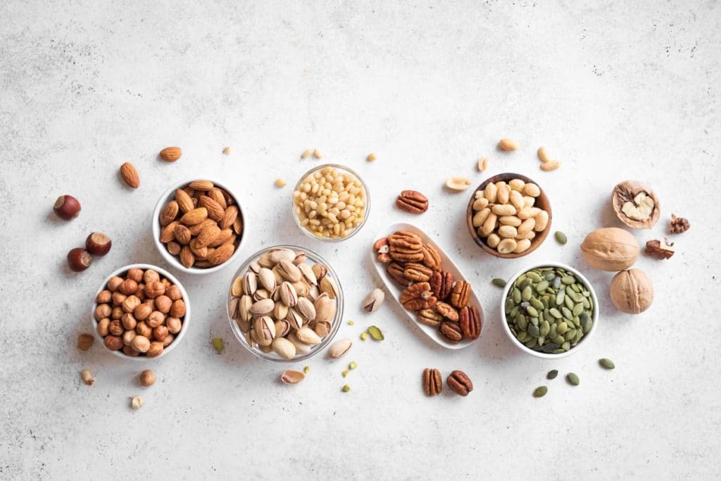 Bowls of nuts and seeds: walnuts, almonds, pistachios, and more