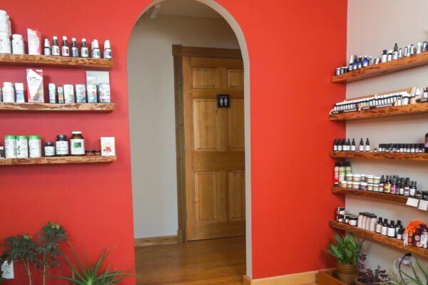 Montpelier office waiting room. Shelves of products, arch doorway leading into hallway