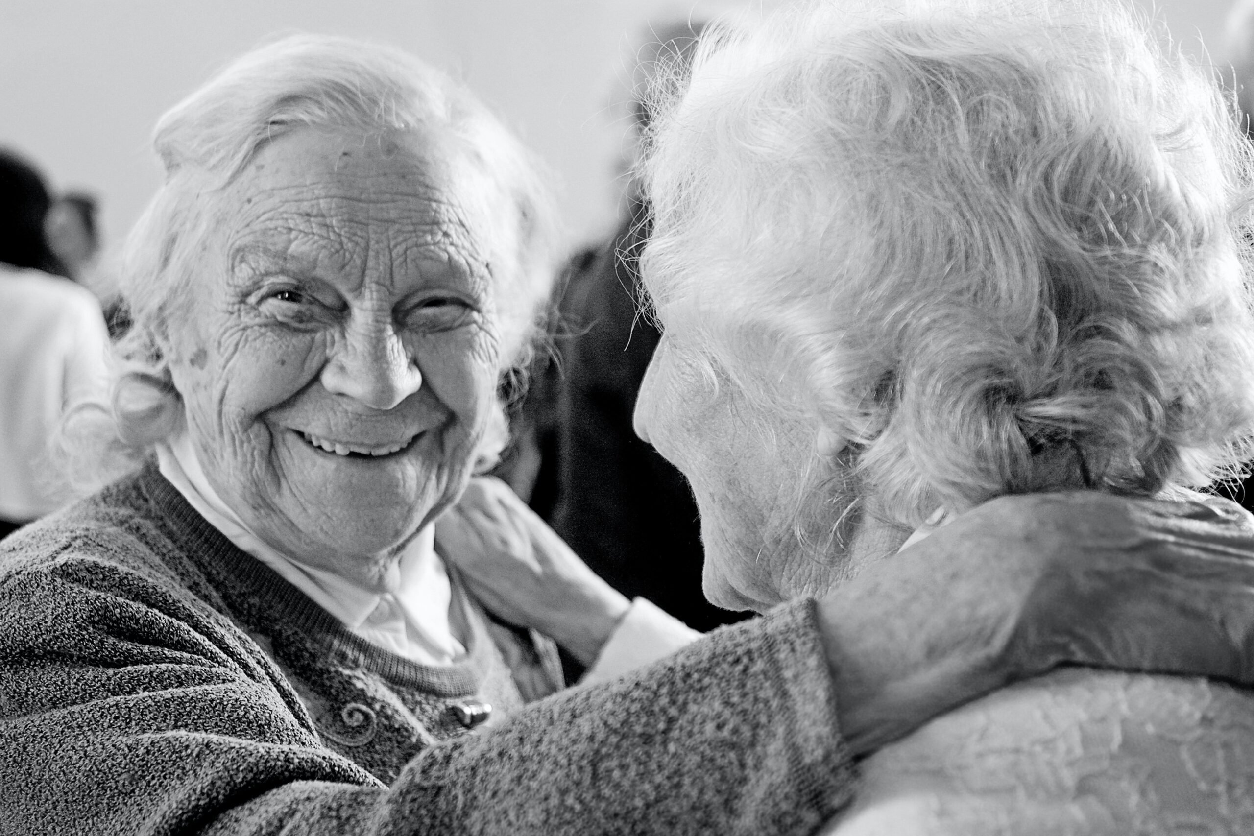 Black and white photo of elderly couple dancing together