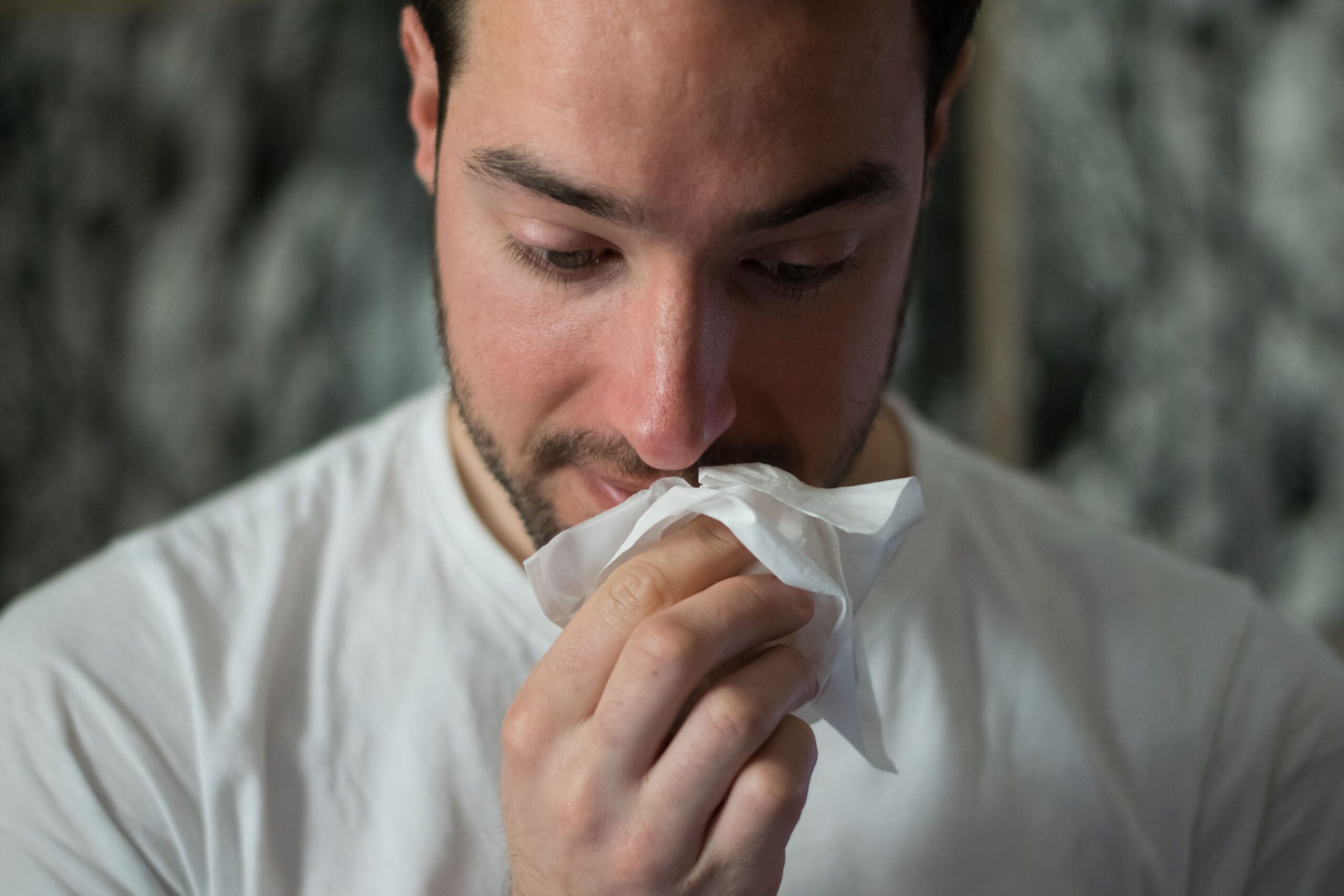 allergies and asthma or illness : person wiping nose with tissue