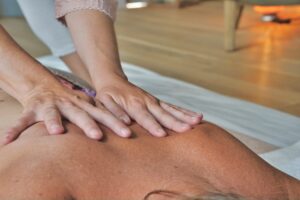 massage therapist massaging patient's back