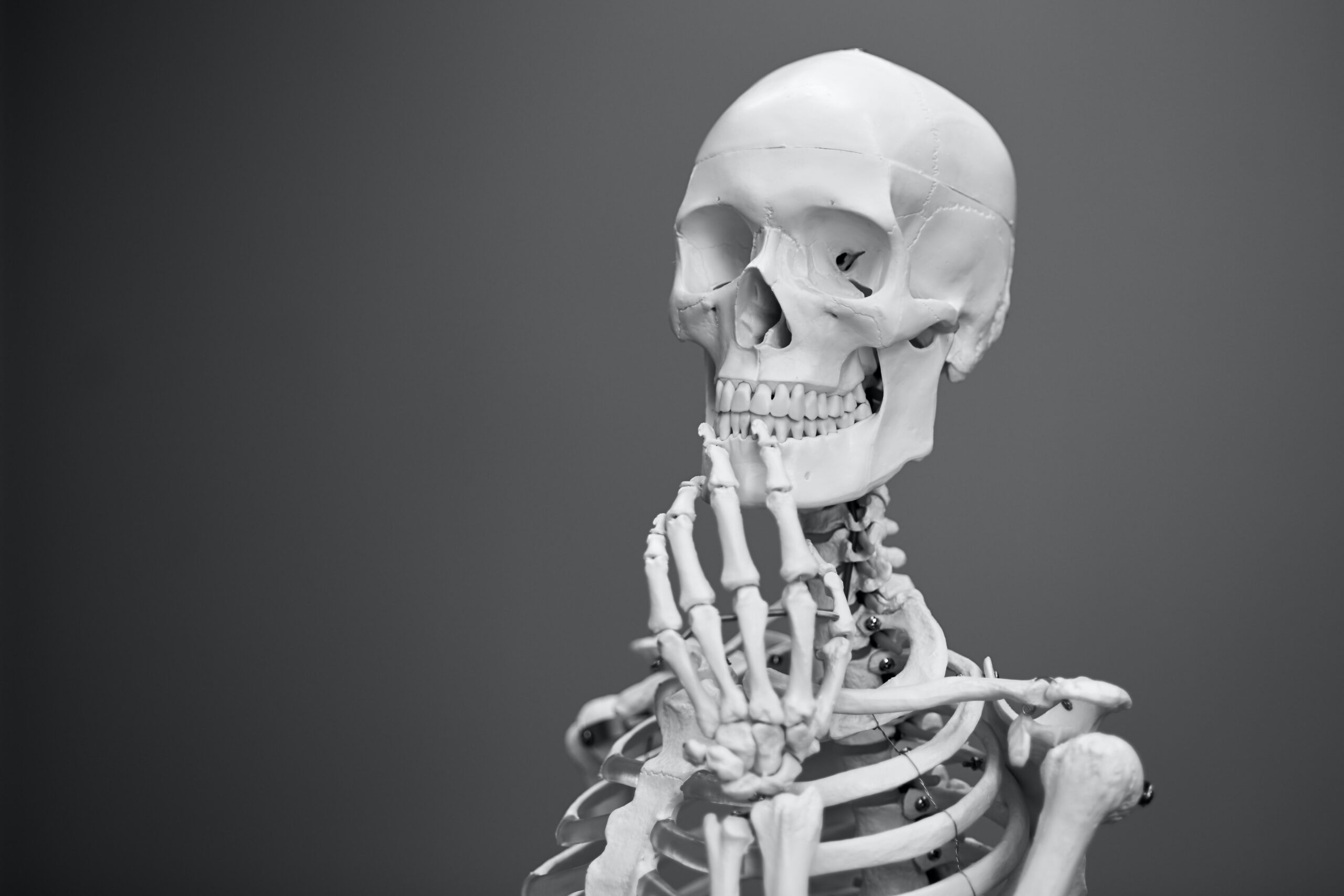 managing arthritis and joint pain. Skeleton with hand on chin